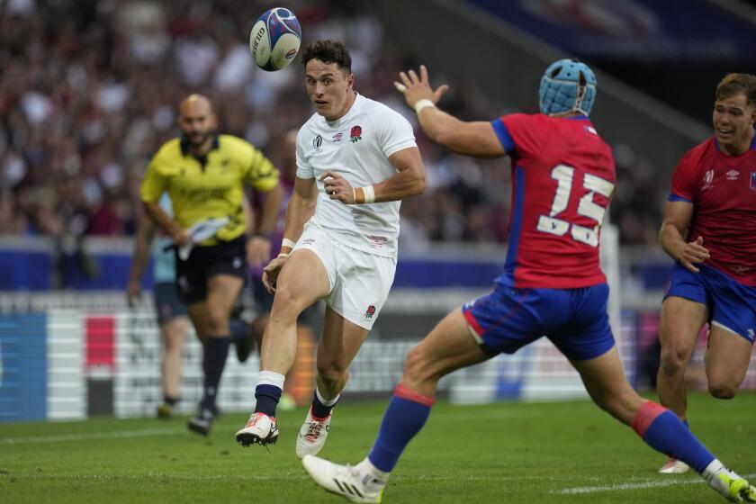 England's Henry Arundell passes the ball past Chile's Francisco Urroz during the Rugby World Cup Pool D match between England and Chile at the Stade Pierre Mauroy in Villeneuve-d'Ascq, outside Lille, Saturday, Sept. 23, 2023. (AP Photo/Themba Hadebe)