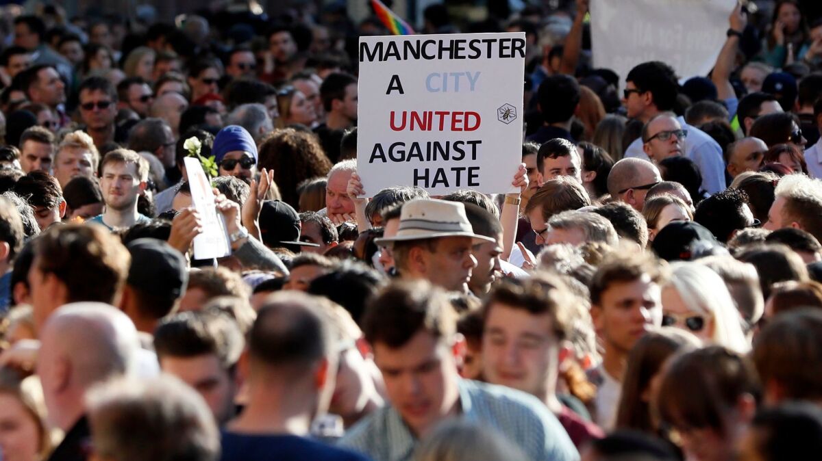 People attend a vigil in Albert Square in Manchester, England, the day after the suicide attack at an Ariana Grande concert.