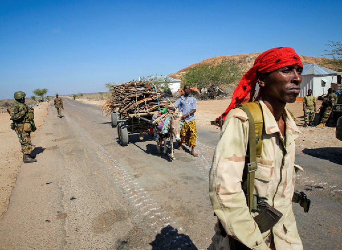 A photo taken and released by the African Union-United Nations Information Support team shows a Somali National Army soldier walking along a road in the town of Buur-Hakba in February.