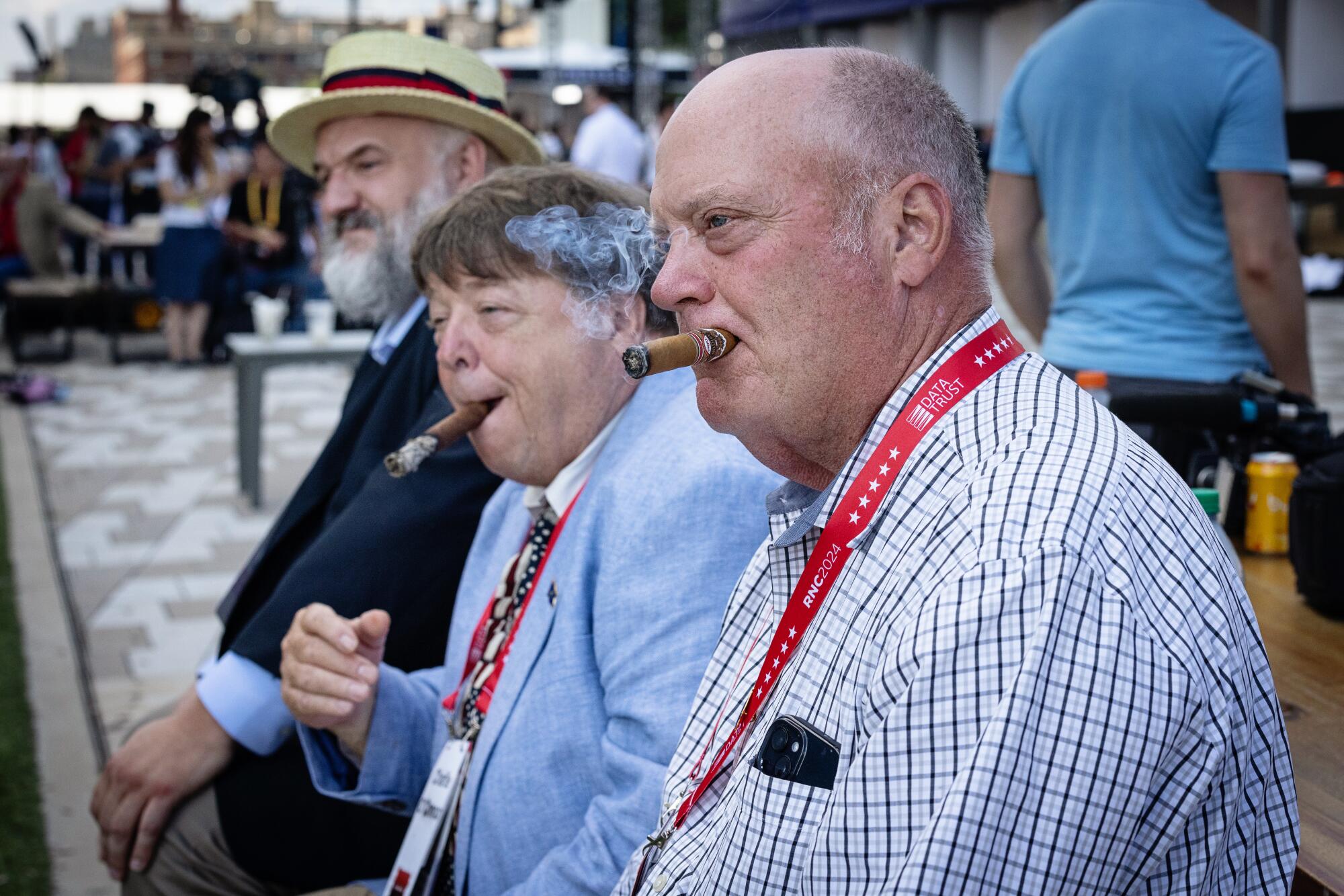 From right - Bill Henney, Charlie O'Connor and Gerald Bergen, sit outside the RNC and enjoy cigars.