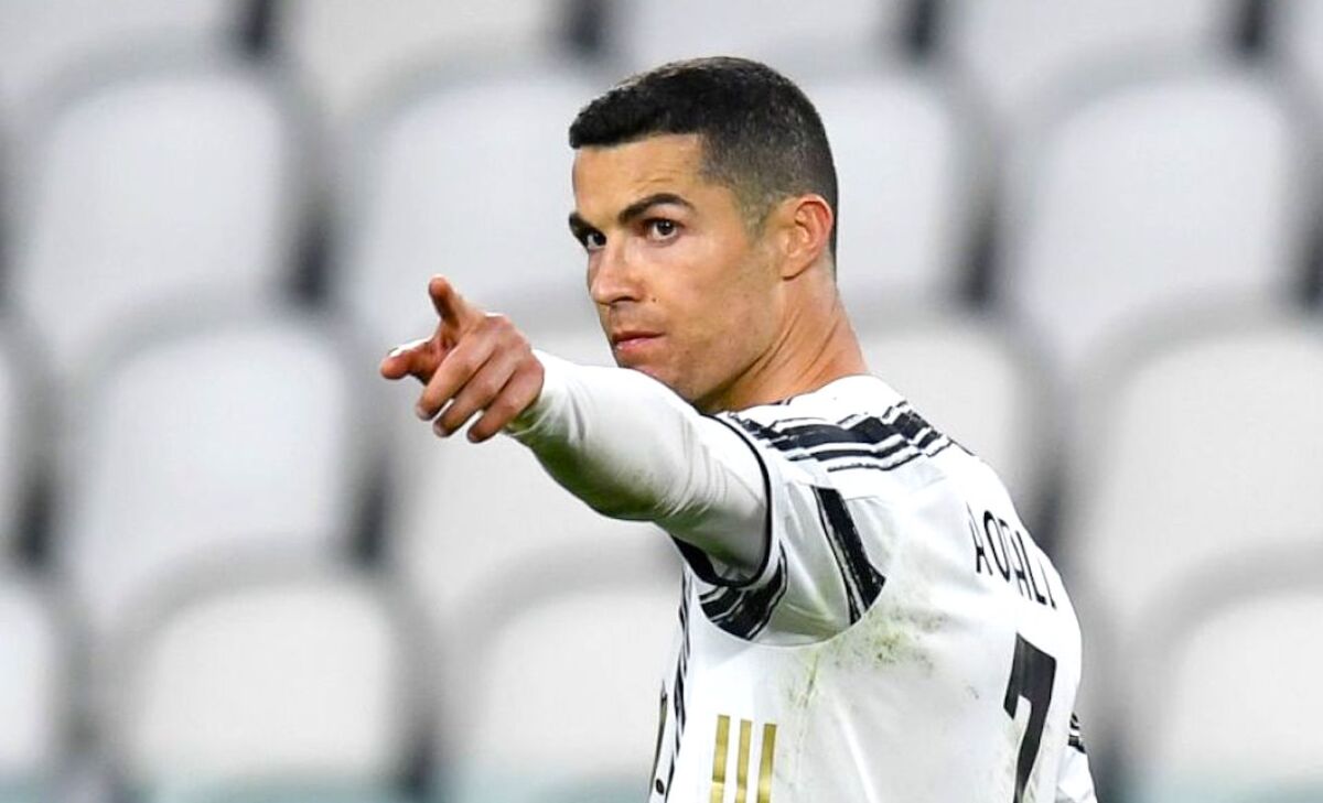 Cristiano Ronaldo points toward a teammate during a game.