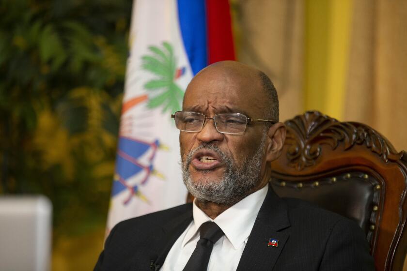 FILE - Haiti's Prime Minister Ariel Henry speaks during an interview with the Associated Press at his private residence in Port-au-Prince, Tuesday, Sept. 28, 2021. Henry and 18 top-ranking officials have requested on the second week of Oct. 2022, the immediate deployment of foreign armed troops as gangs and protesters paralyze the country. (AP Photo/Odelyn Joseph, File)