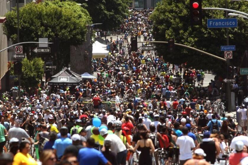 Cyclists crowd an area called the disembark and walk zone on Wilshire Boulevard at Figueroa Boulevard during CicLAvia in June.