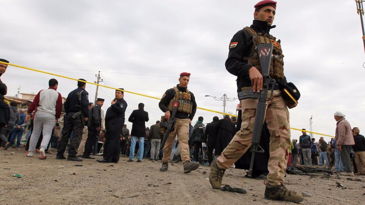 Iraqi security forces cordon off the site of a bomb attack in Sadr City.