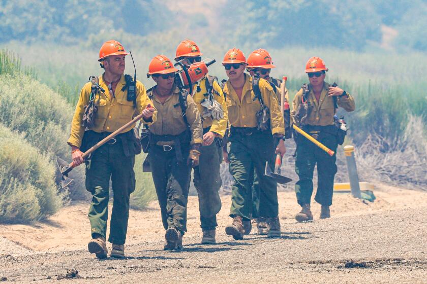 Lebec, CA, Sunday, June 16, 2024 - Crew members of the Little Tujunga Hot Shots hike to positions along Hard Luck Rd to observe a burn out operation near Hungry Valley Road as the Post Fire continues to grow north of Pyramid Lake just west of Interstate 5. (Robert Gauthier/Los Angeles Times)