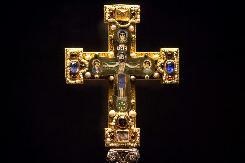 FILE - In this Jan. 9, 2014, file photo, a medieval Cross, part of the Welfenschatz, is displayed at the Bode Museum in Berlin. The heirs of several Nazi-era Jewish art dealers have spent nearly a decade trying to persuade German officials to return the collection of medieval relics valued at more than $250 million. But they didn't make much headway until they filed a lawsuit in an American court. They won a round last week when a federal judge ruled that Germany can be sued in the United States over claims the so-called Guelph Treasure was sold under duress in 1935. ( AP Photo/Markus Schreiber, File)