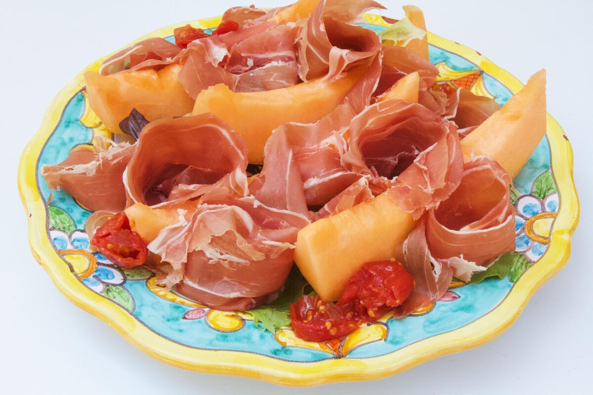 A melon-and-prosciutto salad adorned with imported tomatoes from Sogno Toscano cafe in Santa Monica.