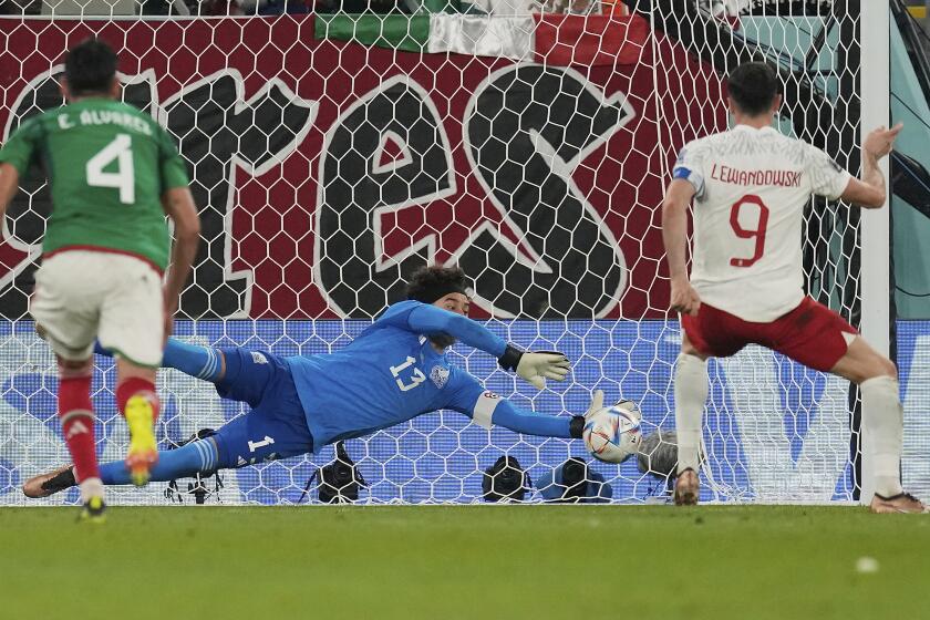 Mexico's goalkeeper Memo Ochoa saves a penalty kick from Poland's Robert Lewandowski 