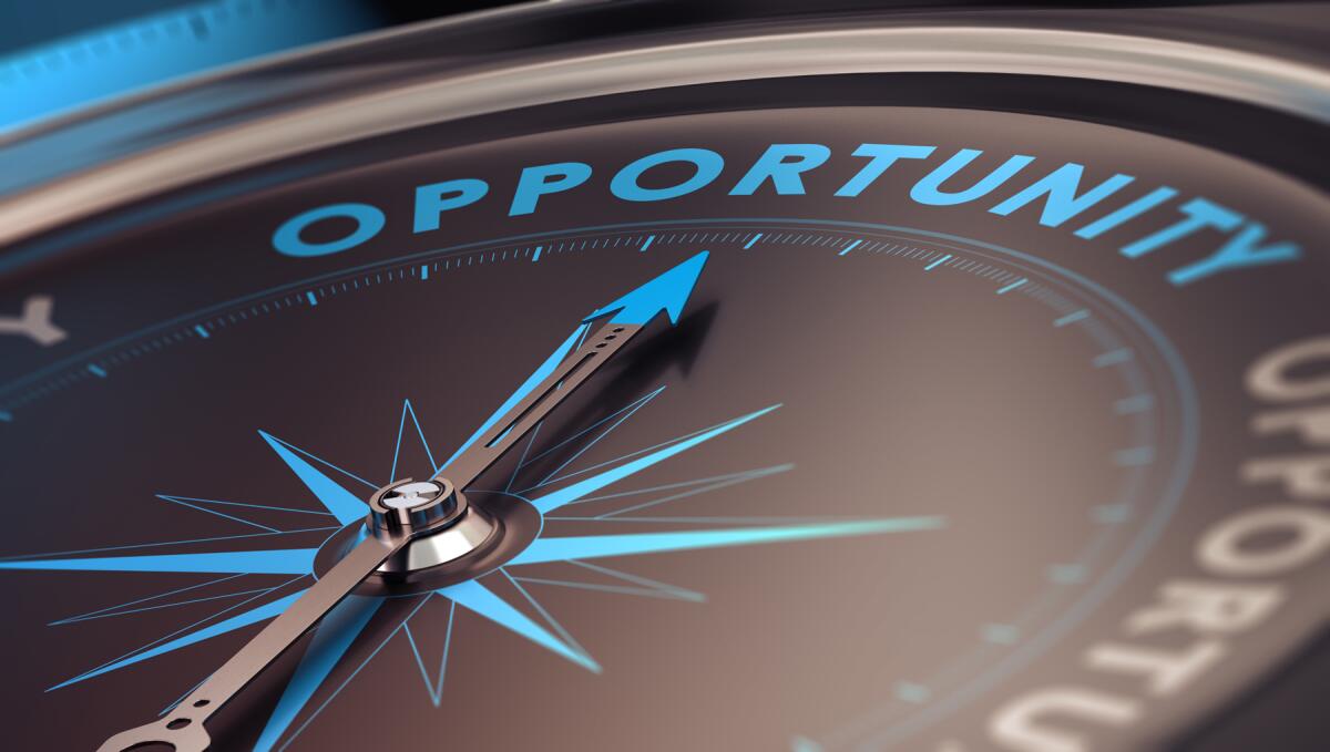 Compass with needle pointing to the word opportunity.