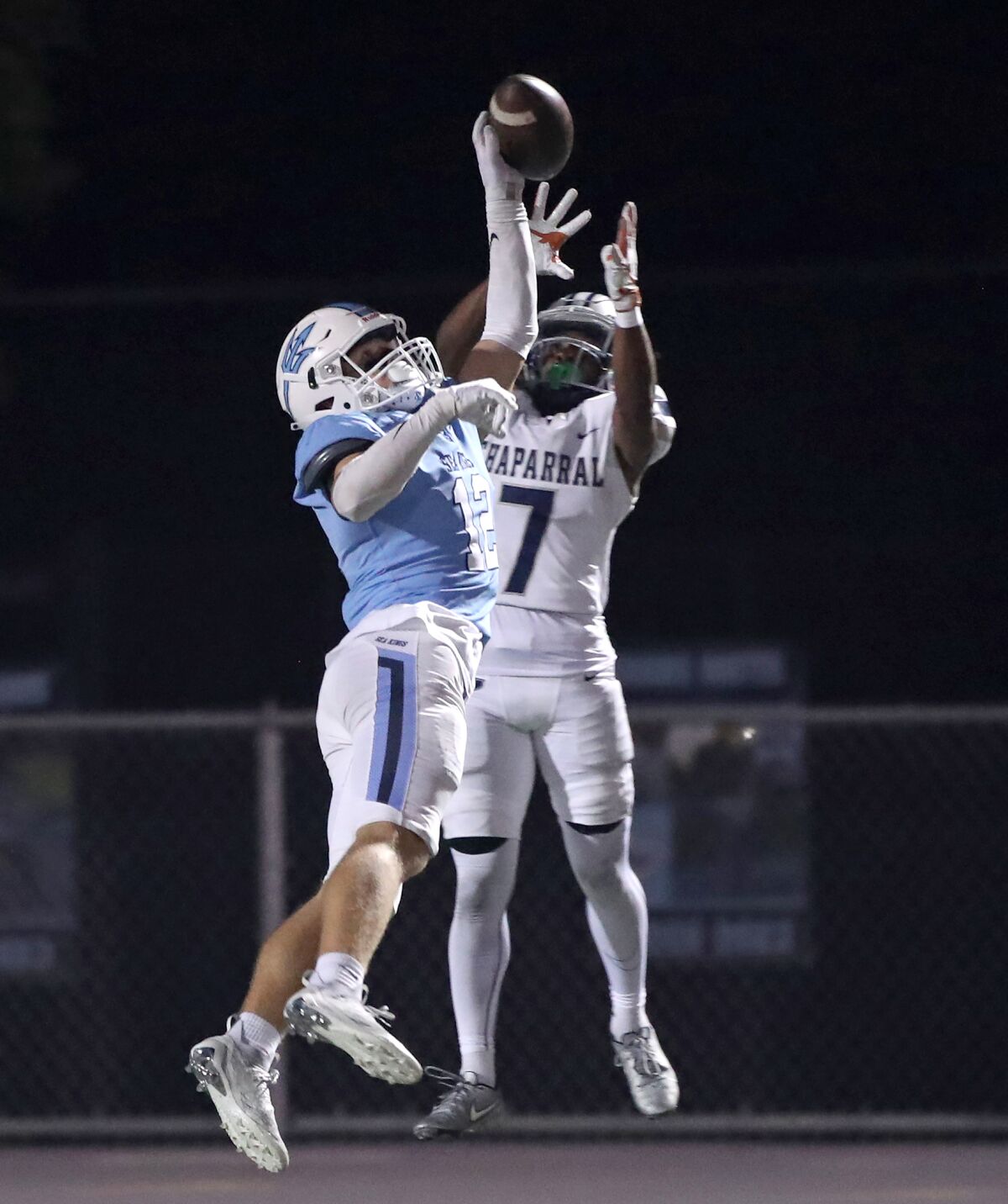 Corona del Mar cornerback Michael Lynch (12) deflects a pass in the end zone intended for Stacy Dobbins (7) on Friday.