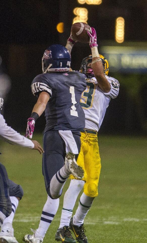 Edison High's Jeremy Maxwell catches a ball over the outstretched hands of Newport Harbor's Quest Truxton (1) during a Sunset League game on Friday. Maxwell scored a touchdown on the play.