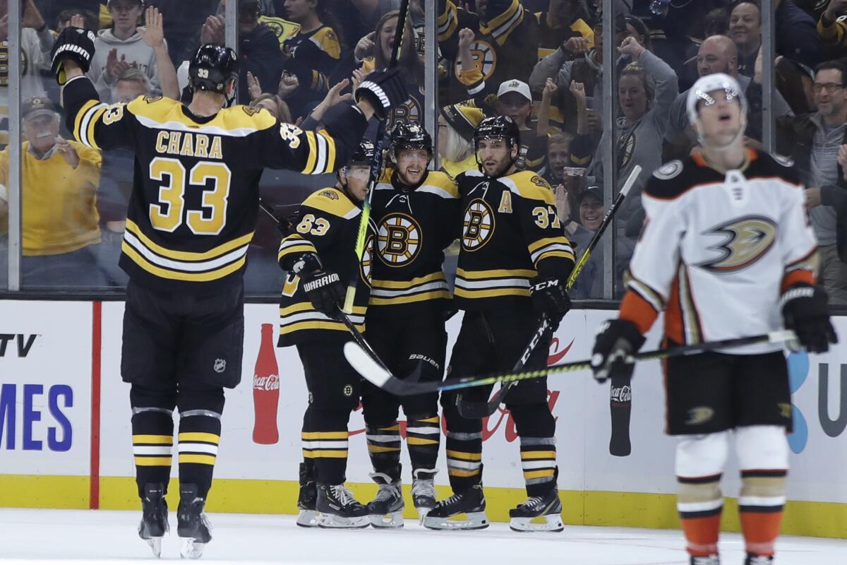 Boston's David Pastrnak, center, celebrates a goal with teammates