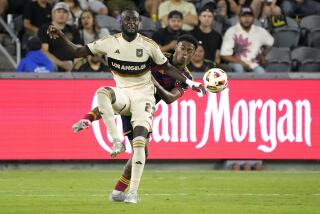 Los Angeles FC forward Kei Kamara, left, and Real Salt Lake midfielder Nelson Palacio battle for the ball during the second half of an MLS soccer match Wednesday, July 17, 2024, in Los Angeles. (AP Photo/Mark J. Terrill)