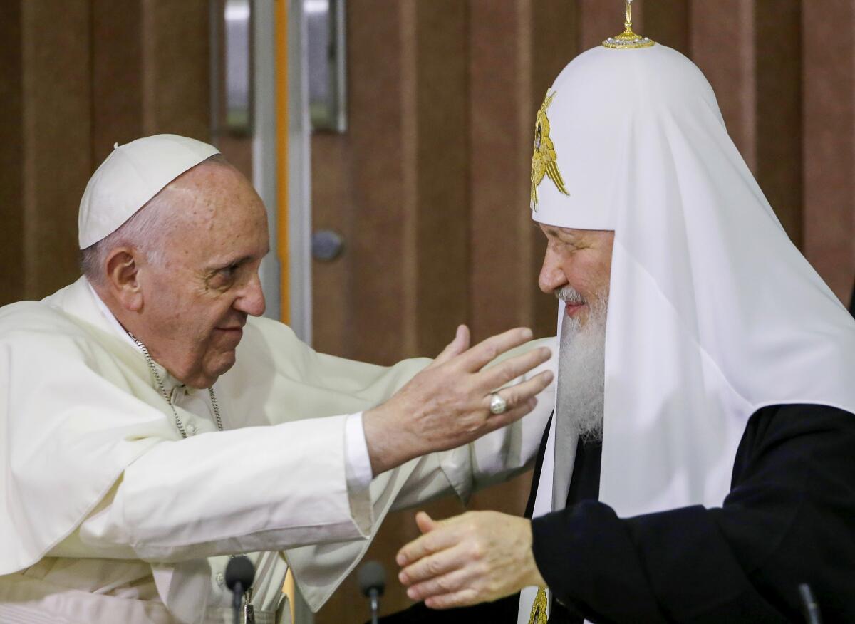 Pope Francis reaching out to embrace Russian Orthodox Patriarch Kirill