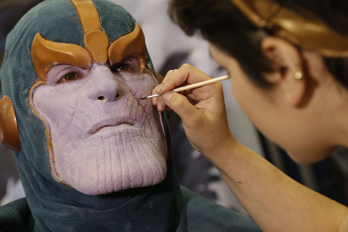 Cinema Make Up School makeup artist Midge Ordonez works on actor Mick Ignis, turning him into the Marvel character Thanos.