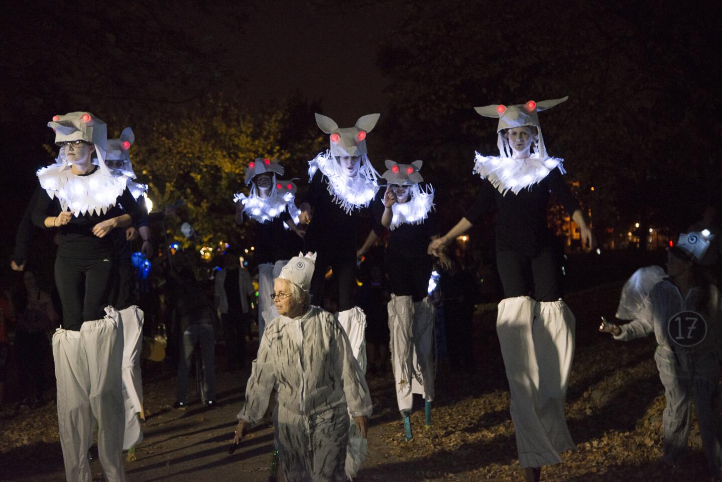 Stilt-walkers from The Nana Project, a Baltimore artistic parade and arts organization walk in the Lantern Parade at Patterson Park on Saturday. The Lantern Parade brought costumes of all sorts, families, artists, performers, and people for all over the city and the country to participate in this yearly Halloween celebration. The Nana Project has participated in the Lantern Parade from the beginning of the event.
