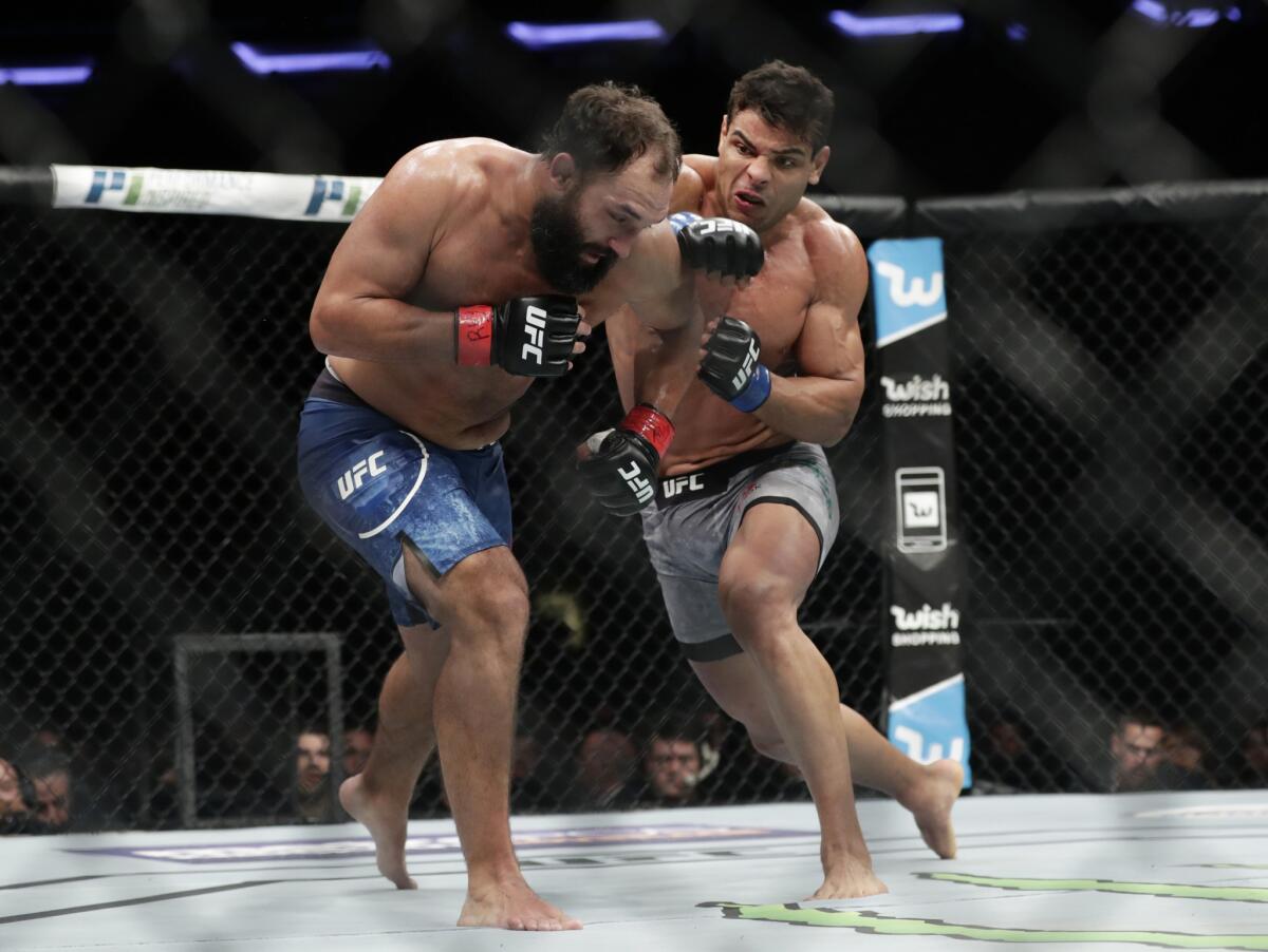 Paulo Costa lands a big right hard against Johny Hendrick during a middleweight bout at UFC 217.