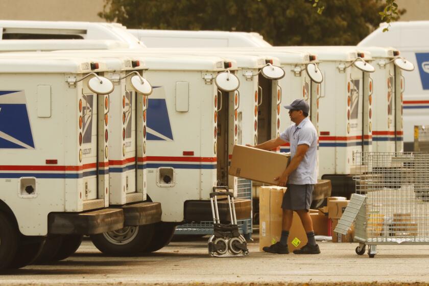 VAN NUYS, CA - SEPTEMBER 09: Mail carriers load their trucks at the United States Postal Service (USPS) located at 15701 Sherman Way in Van Nuys, California on the morning of September 9, 2020. The USPS may be experiencing delays. U.S. Postal Service on Wednesday, Sept. 9, 2020 in Van Nuys, CA. (Al Seib / Los Angeles Times