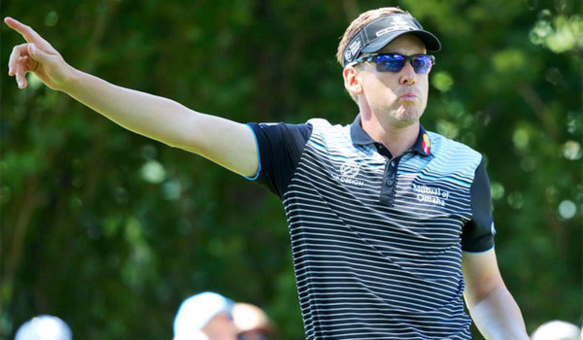 Ian Poulter signals after his tee shot on the 10th hole during the third round of the PGA Championship on Saturday.