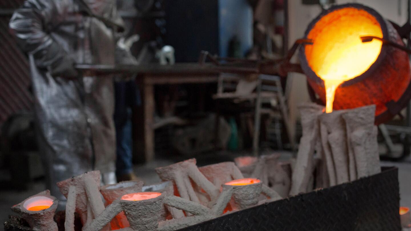 Molten bronze metal is poured into molds in the casting of the solid bronze actor statuette at the American Fine Arts Foundry in Burbank on Tuesday in preparation for the Screen Actors Guild Awards.