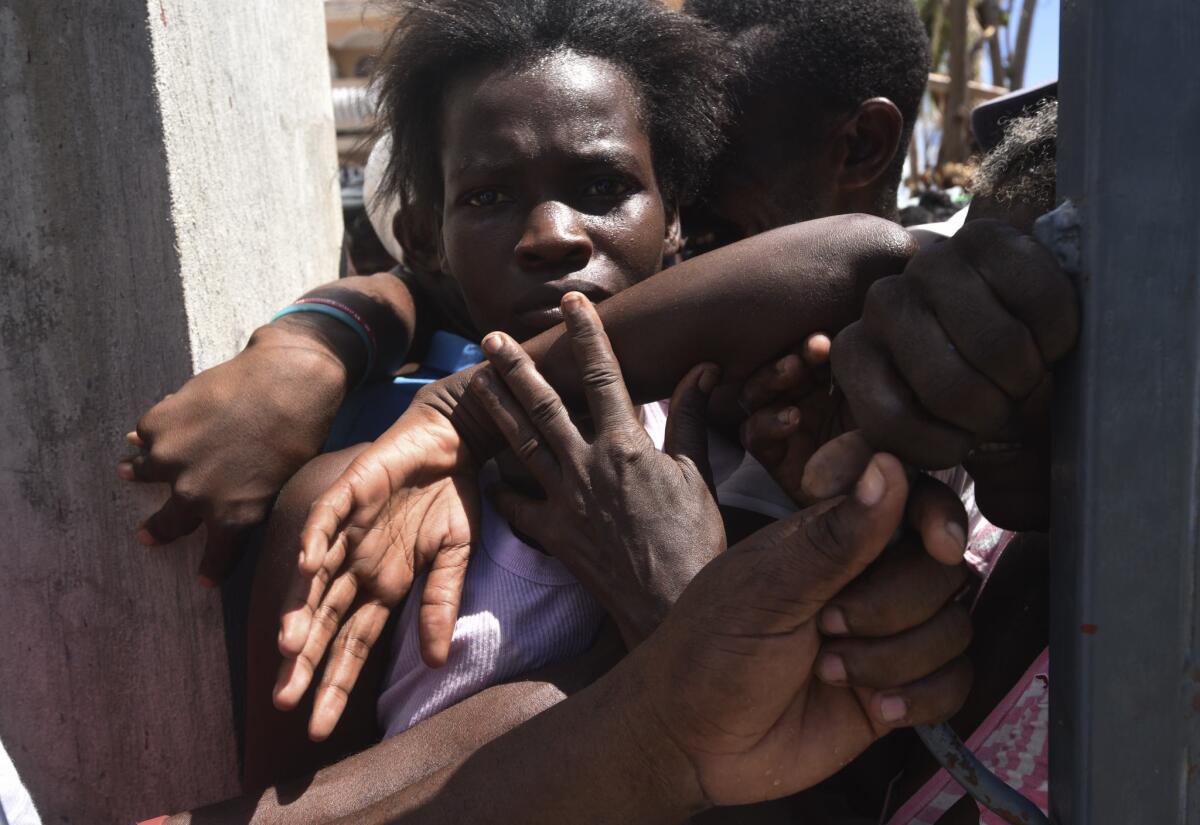 Hurricane Matthew victims wait to receive donated food in Port-Salut, Haiti, on Thursday.