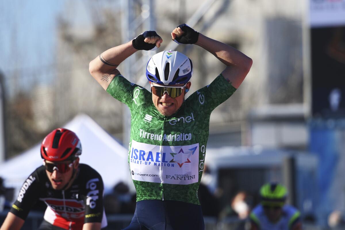 Denmark's Mads Würtz Schmidt celebrates as he crosses the finish line to win the sixth stage of the Tirreno Adriatico cycling race, from Castelraimondo to Lido di Fermo, Italy, Monday, March 15, 2021. (Marco Alpozzi/LaPresse via AP)