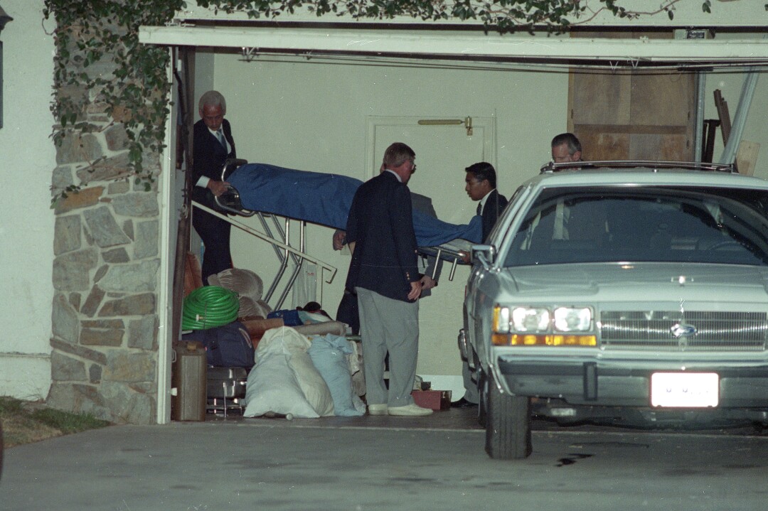 Orange County Coroner's personnel remove the body of Donnie Moore from his home.