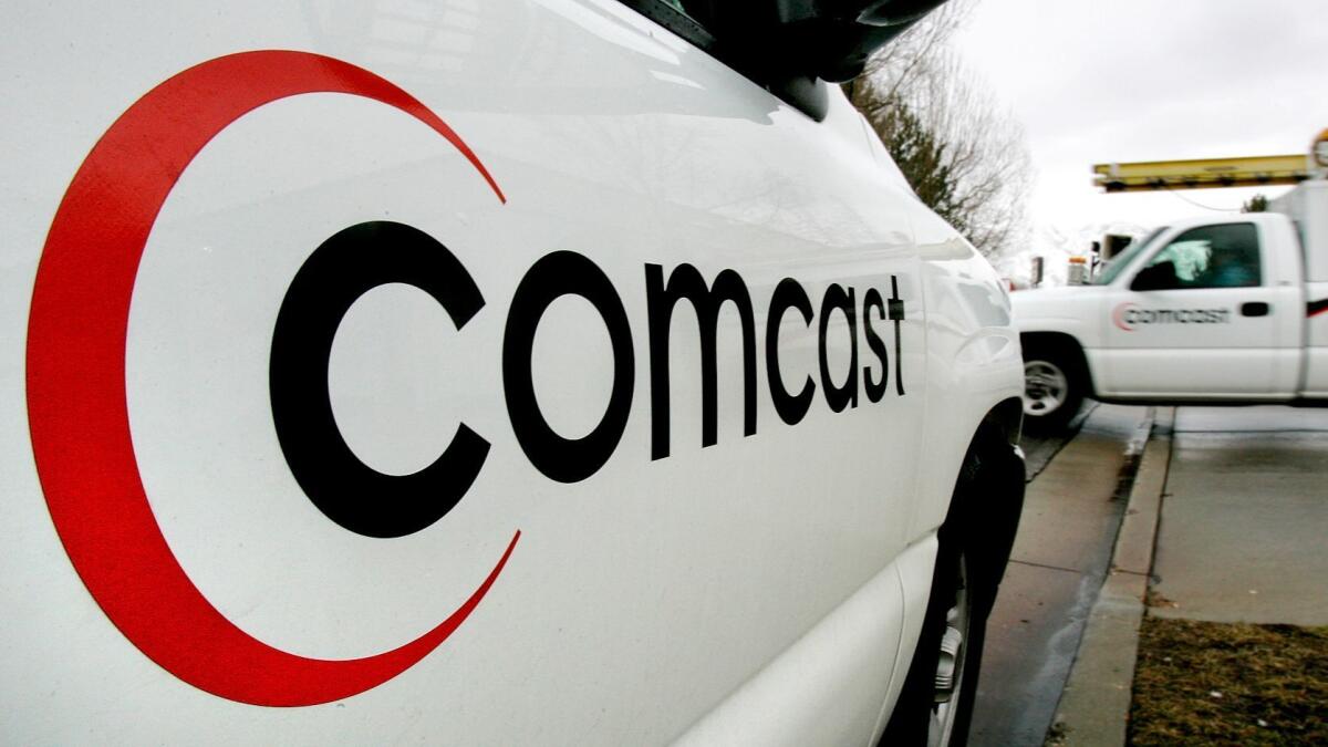 A technician for Comcast Corp. heads out on a job in Salt Lake City in 2006. (Douglas C. Pizac / Associated Press)