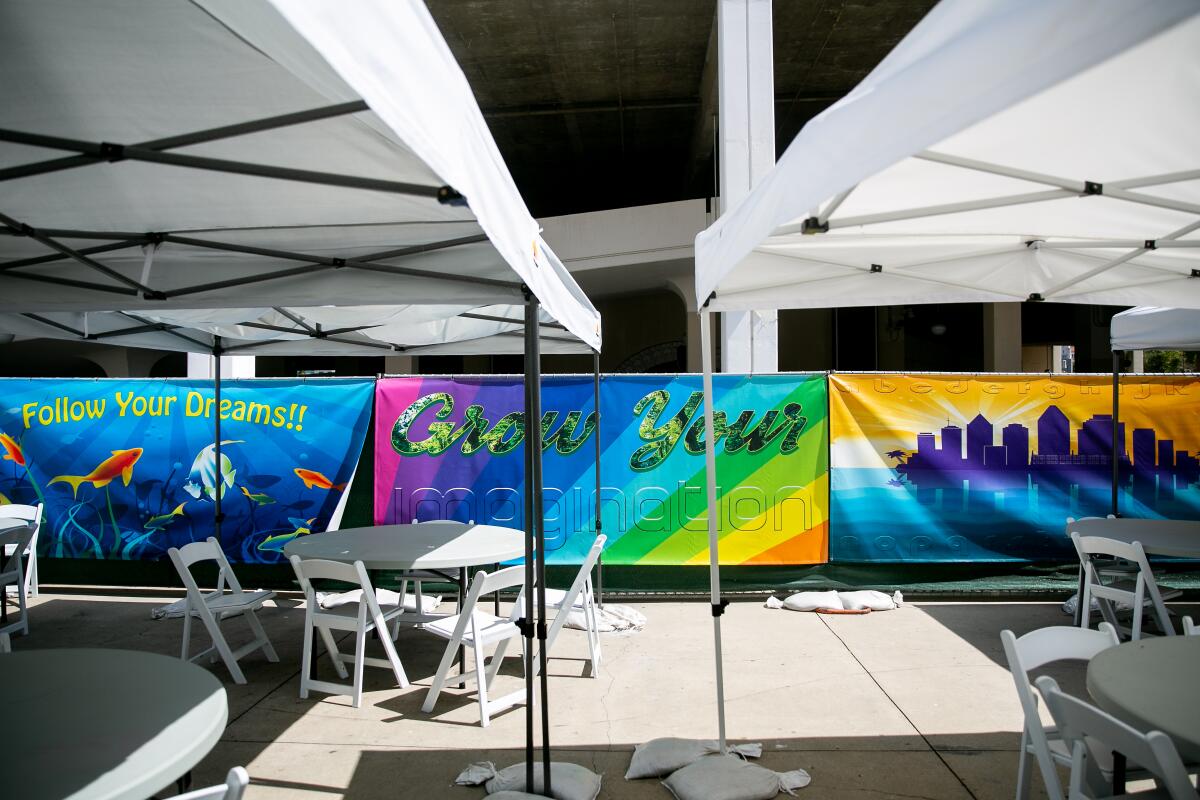 Banners created by the San Diego Opera hang in the outdoor area of the family homeless shelter at Golden Hall on July 5, 2019 in San Diego, California.
