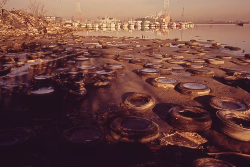 Discarded tires litter the shorefront of Baltimore Harbor in 1973.