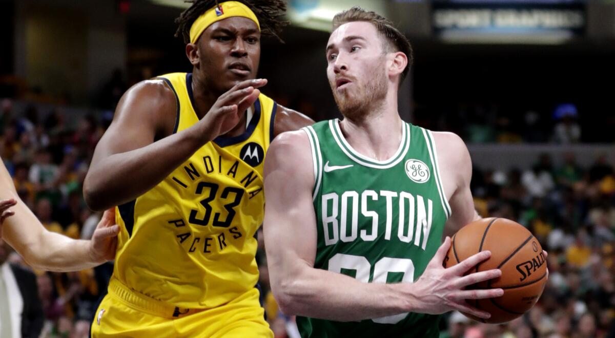 Celtics forward Gordon Hayward (20) drives past Pacers center Myles Turner (33) for a layup during Game 4 on Sunday.