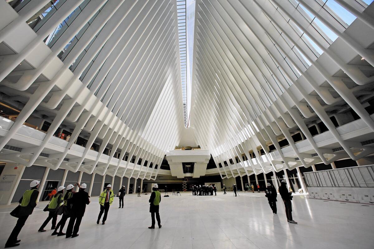 Members of the news media tour the World Trade Center transportation hub, designed by Spanish architect Santiago Calatrava. Its initial phase opens this week.
