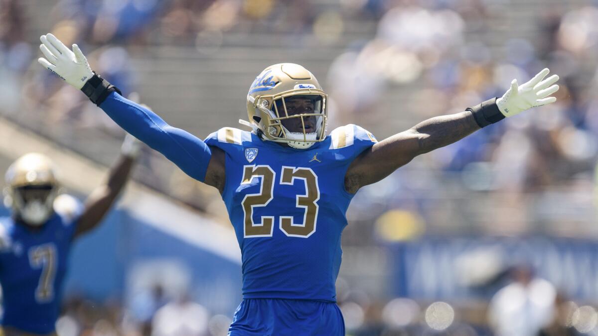 UCLA defensive back Kenny Churchwell III (23) reacts after blocking a pass, with his arms in the air and spread out