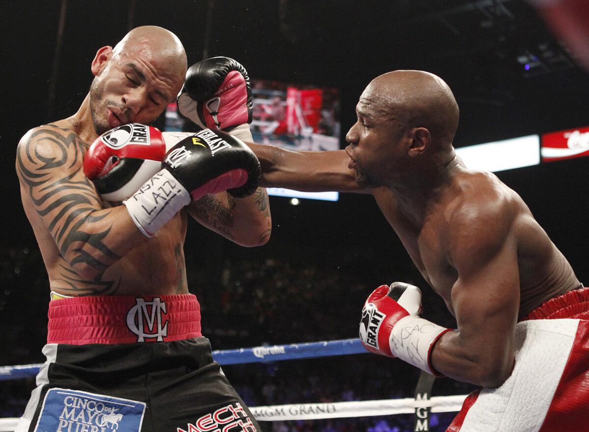 Floyd Mayweather Jr. hits Miguel Cotto during their May 5, 2012, bout.