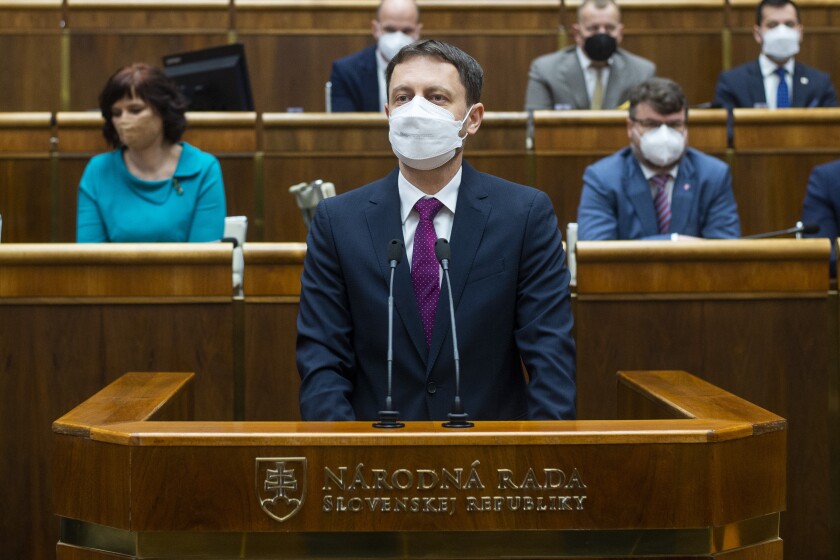 Slovakia Prime Minister Eduard Heger, addresses lawmakers in the parliament in Bratislava, Tuesday May 4, 2021. Eduard Heger's Cabinet obtained a vote of confidence from Parliament on Tuesday. (Jakub Kotian / TASR via AP)