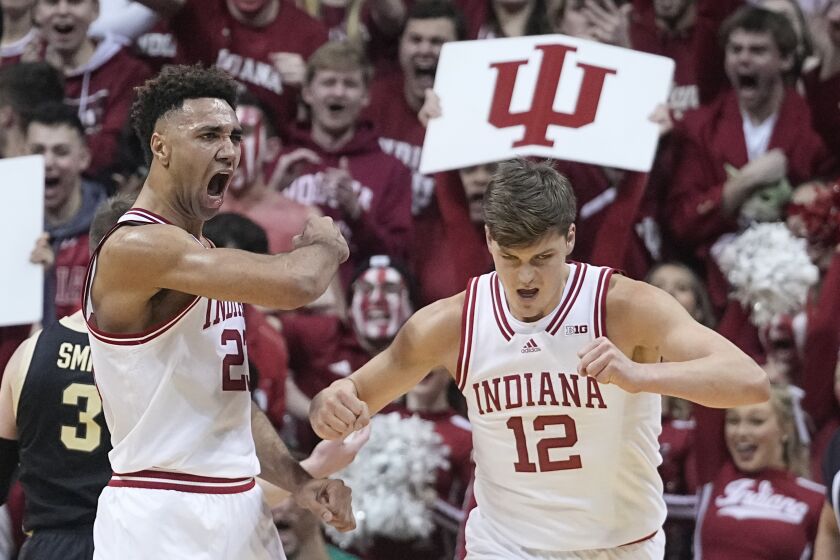 Indiana's Trayce Jackson-Davis, left, reacts with Miller Kopp (12) after Jackson-Davis hit a basket and was fouled during the first half of an NCAA college basketball game against Purdue, Saturday, Feb. 4, 2023, in Bloomington, Ind. (AP Photo/Darron Cummings)