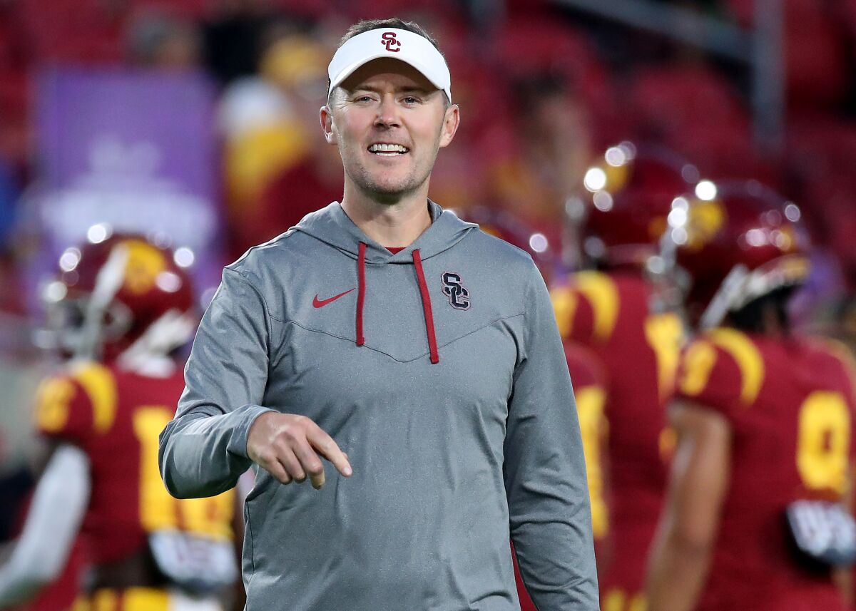 USC coach Lincoln Riley directs pre-game warmups before the Trojans face off against Fresno State 