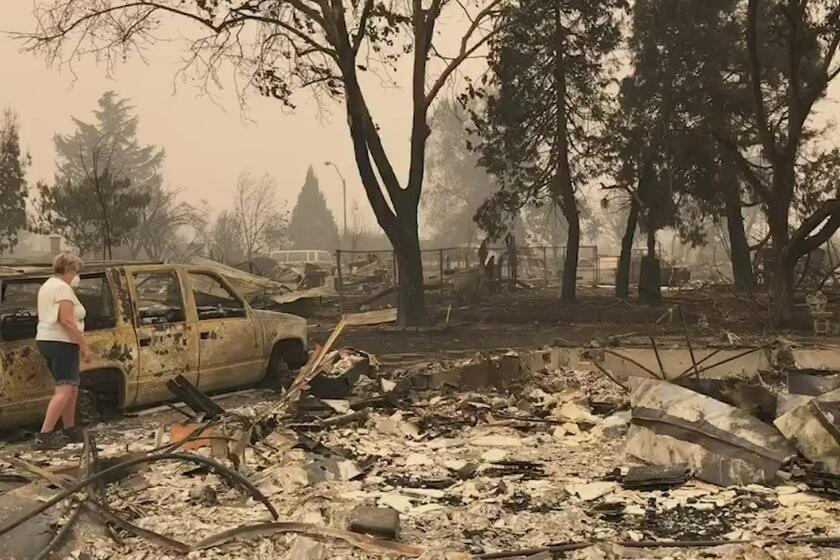 Oregon woman returns to remains of her home after deadly wildfire burns through neighborhood