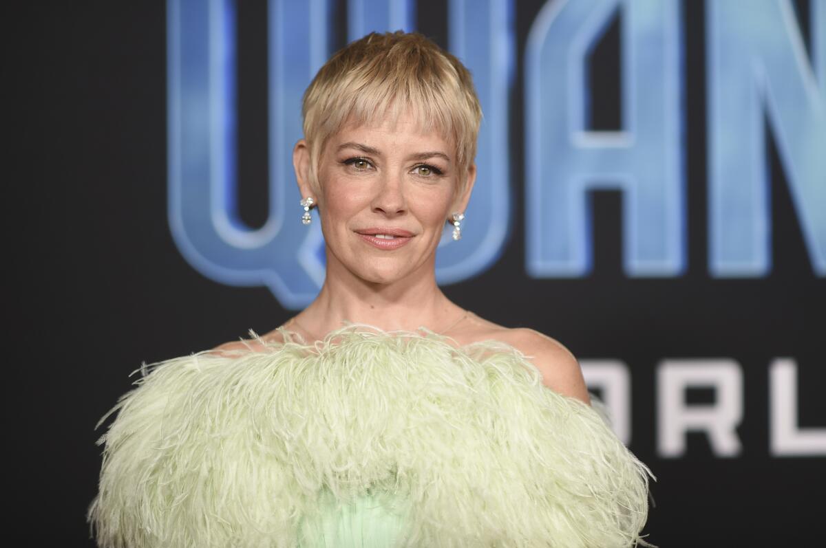 Evangeline Lilly rocking a blond pixie cut, diamond earrings and a lime-green strapless gown with a feathery bust line
