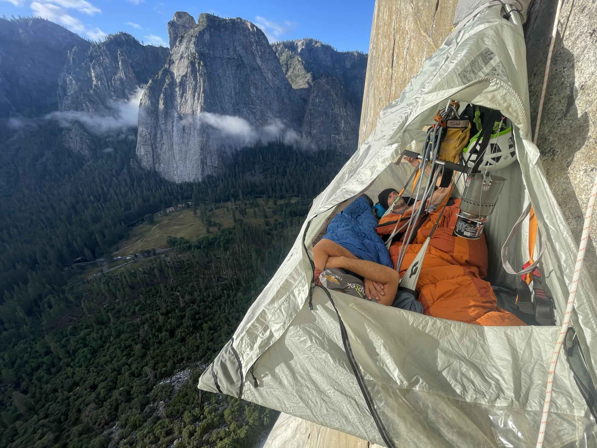 Zuko Carrasco and a climbing partner sleep on a tented platform anchored to El Capitan. 