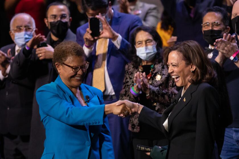 LOS ANGELES, CA - DECEMBER 11: Los Angeles Mayor Karen Bass shakes hands with Vice President Kamala Harris following the oath of office during inauguration ceremonies at Microsoft Theater on Sunday, Dec. 11, 2022 in Los Angeles, CA. (Myung J. Chun / Los Angeles Times)