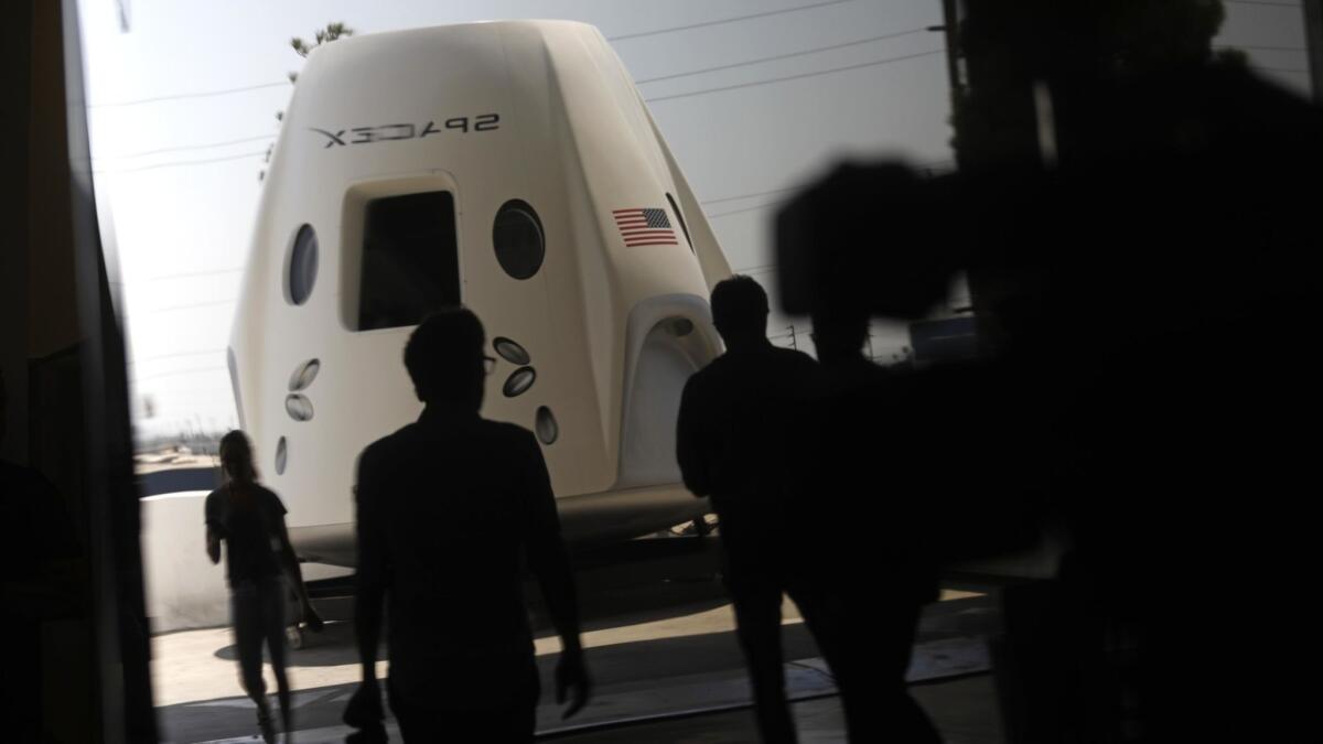 A mock-up of SpaceX's Crew Dragon spacecraft is on display Aug. 13 at the company's Hawthorne headquarters.