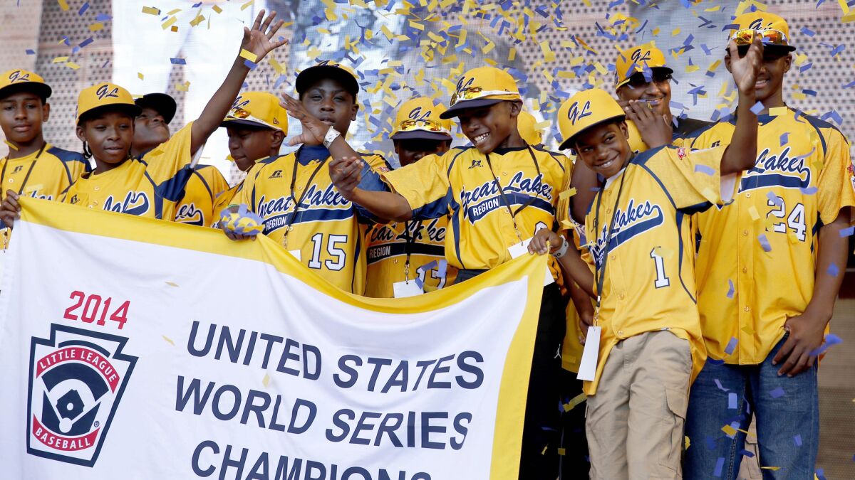 Jackie Robinson West Little League players attend a rally in celebration of their national title in Chicago on in August. Jackie Robinson West was stripped of its championship by Little League International on Wednesday.