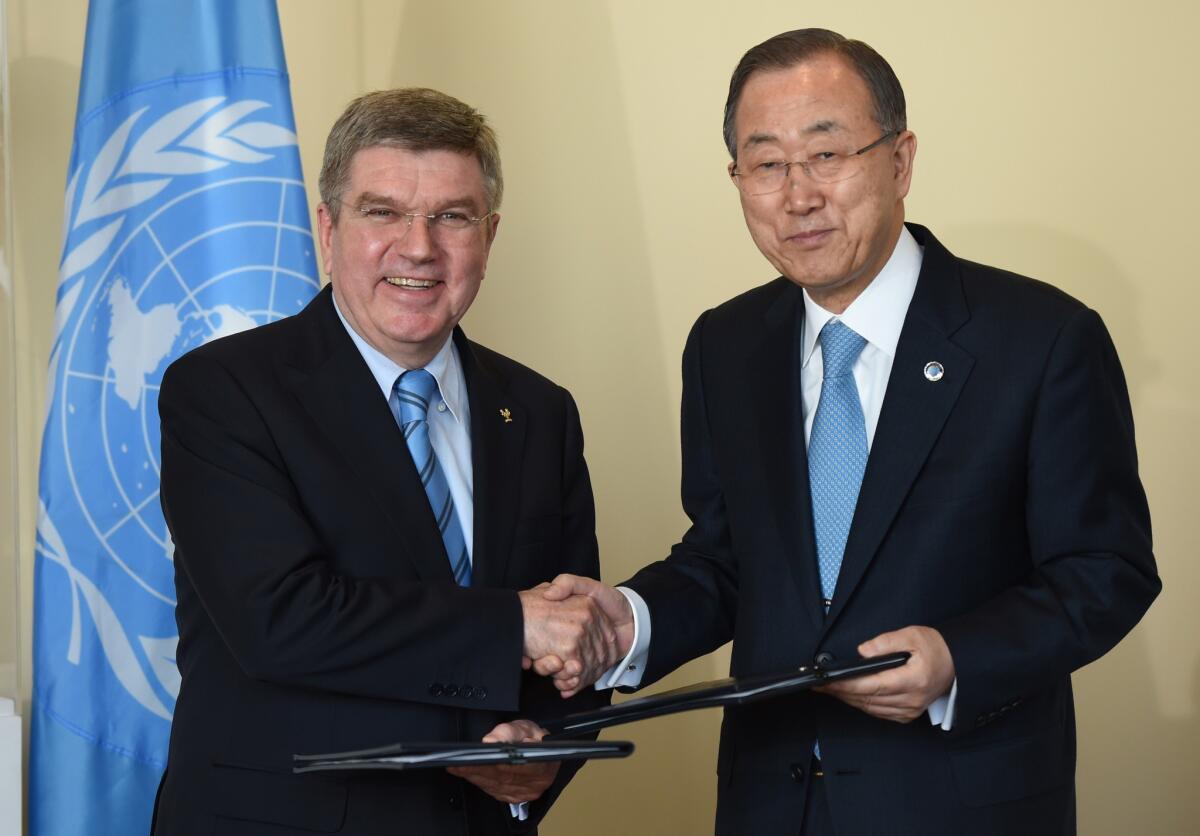 International Olympic Committee President Thomas Bach, left, and United Nations Secretary-General Ban Ki-moon shake hands Monday at the U.N. after signing a memorandum of understanding between the two organizations.