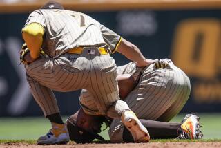 San Diego Padres second baseman Xander Bogaerts (2) kneels after injury fielding a ball hit by Atlanta Braves' Ronald Acuña Jr. in the third inning of a baseball game, Monday, May 20, 2024, in Atlanta. (AP Photo/Mike Stewart)