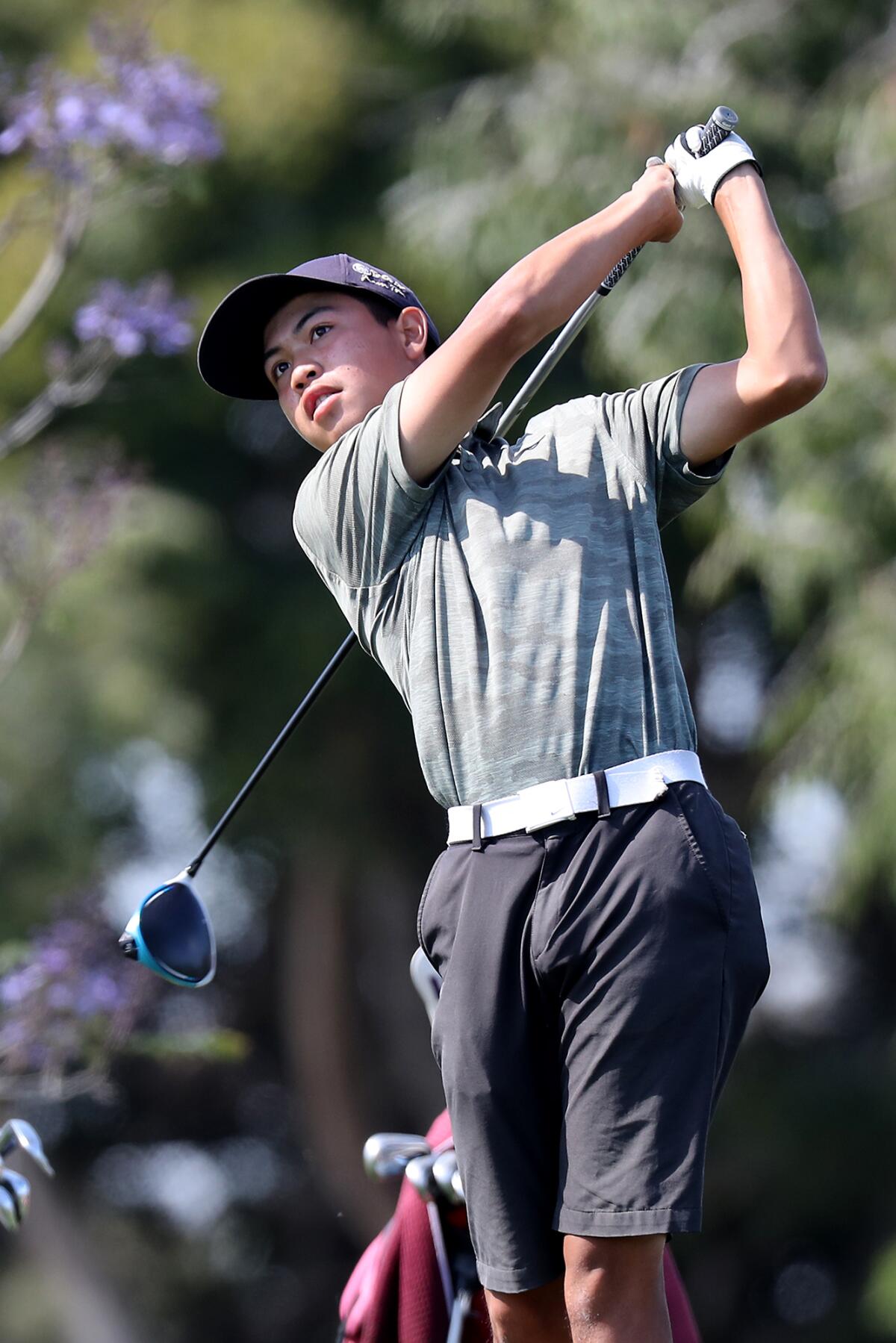 Costa Mesa's Cristopher Rodriguez tees off on Hole No. 4 against Estancia during the Battle for the Bell golf match.