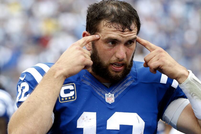 Colts quarterback Andrew Luck, talking to teammates on the sideline during Sunday's win against the Titans, has been limited in practice this week because of a shoulder injury.