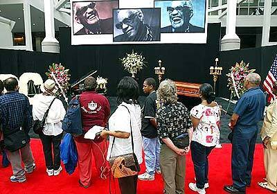 Fans and mourners file past the casket of legendary musician Ray Charles at the Los Angeles Convention Center.