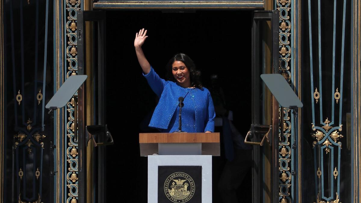 San Francisco Mayor London Breed waves during her inauguration at San Francisco City Hall on Wednesday.