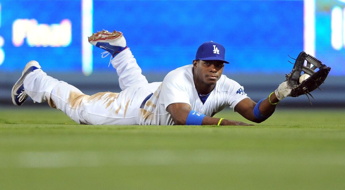 Dodgers right fielder Yasiel Puig shows the ball to the umpire after making a diving catch in the sixth inning of the Dodgers' 4-1 loss to the Arizona Diamondbacks on Wednesday.